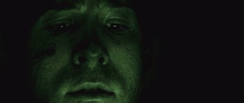 Movie still from “Buried” (2010), directed by Rodrigo Cortés – A man's face in the dark; Extreme Close Up shot, Overhead angle