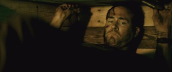 Movie still from “Buried” (2010), directed by Rodrigo Cortés – A person in a dark room; Close Up shot, Low angle