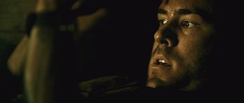 Movie still from “Buried” (2010), directed by Rodrigo Cortés – A man's face in the dark; Extreme Close Up shot, Over the shoulder angle