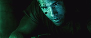 Movie still from “Buried” (2010), directed by Rodrigo Cortés – A person wearing a green shirt; Close Up shot, Overhead angle