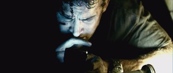 Movie still from “Buried” (2010), directed by Rodrigo Cortés – A person holding a cell phone; Close Up shot, Low angle