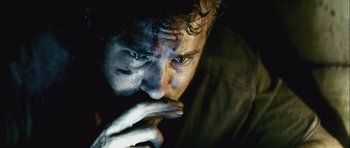 Movie still from “Buried” (2010), directed by Rodrigo Cortés – A person with his hand to his face; Extreme Close Up shot, Over the shoulder angle