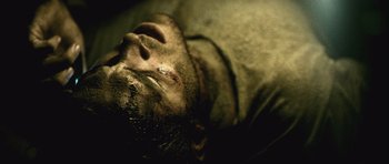 Movie still from “Buried” (2010), directed by Rodrigo Cortés – A person laying on the ground; Extreme Close Up shot, Overhead angle