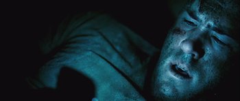 Movie still from “Buried” (2010), directed by Rodrigo Cortés – View of a person's arm and hand; Extreme Close Up shot, Overhead angle