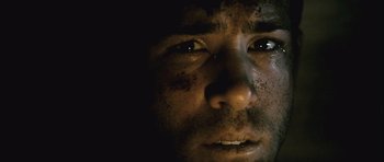 Movie still from “Buried” (2010), directed by Rodrigo Cortés – A man's face in the dark; Extreme Close Up shot, Low angle