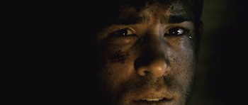 Movie still from “Buried” (2010), directed by Rodrigo Cortés – A man's face with dirt on his face; Extreme Close Up shot, Low angle