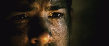 Movie still from “Buried” (2010), directed by Rodrigo Cortés – A man's face with dirt on his face; Extreme Close Up shot, Low angle