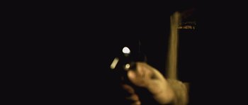 Movie still from “Buried” (2010), directed by Rodrigo Cortés – A person holding a cell phone in their hand; Extreme Close Up shot, Low angle