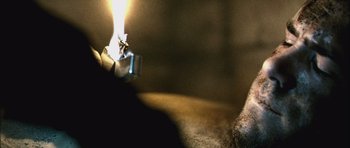 Movie still from “Buried” (2010), directed by Rodrigo Cortés – A candle that is lit on the floor; Extreme Close Up shot, High angle