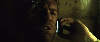 Movie still from “Buried” (2010), directed by Rodrigo Cortés – A person talking on a cell phone; Close Up shot, Low angle