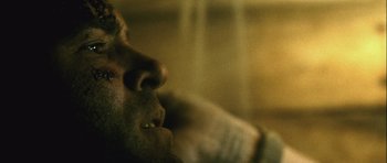 Movie still from “Buried” (2010), directed by Rodrigo Cortés – A man's face as he looks into the distance; Extreme Close Up shot, Overhead angle
