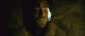 Movie still from “Buried” (2010), directed by Rodrigo Cortés – A man with a cell phone in his hand; Close Up shot, Overhead angle