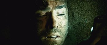 Movie still from “Buried” (2010), directed by Rodrigo Cortés – A man's face in the dark; Extreme Close Up shot, Overhead angle