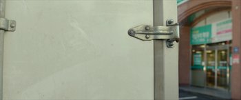 Movie still from “Burning” (2018), directed by Lee Chang-dong – A hinge on a white door; Extreme Close Up shot, Low angle