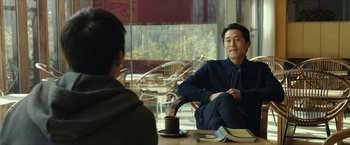 A man sitting in front of another man at a table
