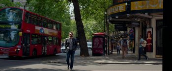 Movie still from “Burnt” (2015), directed by John Wells – A man walking down a street near a tree; Wide shot, Low angle