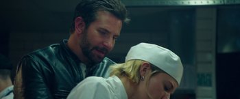 Movie still from “Burnt” (2015), directed by John Wells – A man and a woman are looking at each other; Close Up shot, Over the shoulder angle