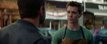 Movie still from “Burnt” (2015), directed by John Wells – A man wearing an apron talking to another man; Close Up shot, Over the shoulder angle