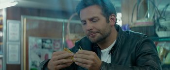Movie still from “Burnt” (2015), directed by John Wells – A person eating a sandwich; Close Up shot, Over the shoulder angle