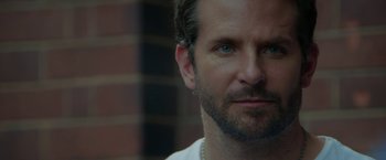 Movie still from “Burnt” (2015), directed by John Wells – A man with a beard looking at the camera; Close Up shot, Over the shoulder angle