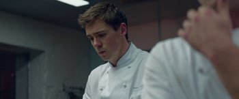 Movie still from “Burnt” (2015), directed by John Wells – A man in a chef's outfit looking down; Close Up shot, Low angle