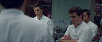 Movie still from “Burnt” (2015), directed by John Wells – A man standing in front of a mirror in a kitchen; Close Up shot, Over the shoulder angle