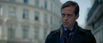 Movie still from “Burnt” (2015), directed by John Wells – A person wearing a suit and tie; Close Up shot, Over the shoulder angle