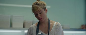 Movie still from “Burnt” (2015), directed by John Wells – A woman is looking down at her cell phone; Close Up shot, Low angle