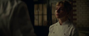 Movie still from “Burnt” (2015), directed by John Wells – A woman in a white shirt is looking into the distance; Close Up shot, Low angle