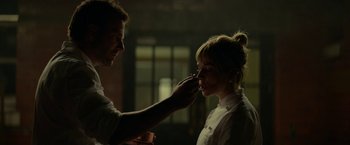 Movie still from “Burnt” (2015), directed by John Wells – A man putting makeup on a woman's face; Close Up shot, Over the shoulder angle