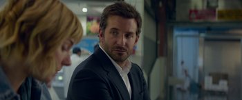 Movie still from “Burnt” (2015), directed by John Wells – A person wearing a suit and tie; Close Up shot, Over the shoulder angle