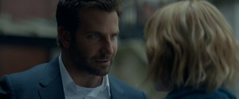 Movie still from “Burnt” (2015), directed by John Wells – A person wearing a suit and tie; Close Up shot, Over the shoulder angle