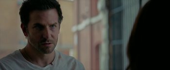 Movie still from “Burnt” (2015), directed by John Wells – A man's face in front of a brick building; Close Up shot, Over the shoulder angle