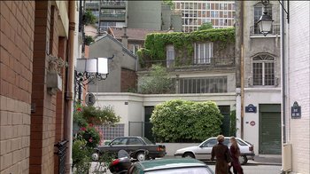 Movie still from “Caché” (2005), directed by Michael Haneke – A couple of cars parked on the side of the street; Extreme Wide shot, Over the shoulder angle