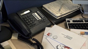 Movie still from “Caché” (2005), directed by Michael Haneke – An office desk with a phone and a notebook; Extreme Close Up shot, High angle