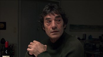 Movie still from “Caché” (2005), directed by Michael Haneke – A person wearing a green sweater; Close Up shot, Over the shoulder angle