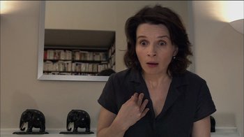 Movie still from “Caché” (2005), directed by Michael Haneke – A woman with her hands on her chest; Close Up shot, Over the shoulder angle