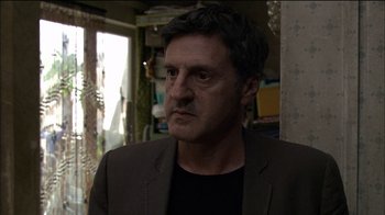 Movie still from “Caché” (2005), directed by Michael Haneke – A person wearing a jacket; Close Up shot, Over the shoulder angle