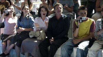 Movie still from “Caché” (2005), directed by Michael Haneke – A group of people sitting in a stadium; Medium shot, Over the shoulder angle