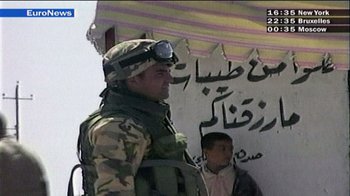 Movie still from “Caché” (2005), directed by Michael Haneke – A man in military fatigues standing next to a man in military fatigues; Wide shot, Over the shoulder angle