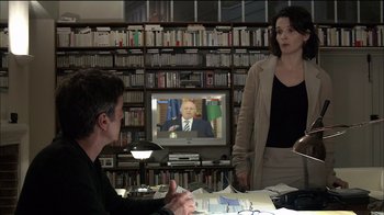 Movie still from “Caché” (2005), directed by Michael Haneke – A man and a woman in front of a television; Medium shot, Over the shoulder angle