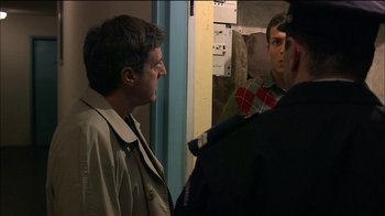 Movie still from “Caché” (2005), directed by Michael Haneke – Two men are looking at each other in a mirror; Medium shot, Over the shoulder angle