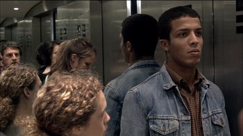 Movie still from “Caché” (2005), directed by Michael Haneke – A group of young people in a elevator; Close Up shot, Over the shoulder angle