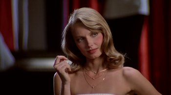 Movie still from “Caddyshack” (1980), directed by Harold Ramis – A woman with long blonde hair wearing a white dress; Close Up shot, Low angle