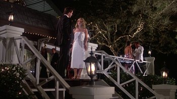 Movie still from “Caddyshack” (1980), directed by Harold Ramis – A man and a woman standing on a porch; Wide shot, Low angle