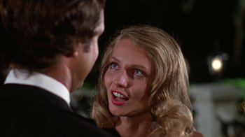 Movie still from “Caddyshack” (1980), directed by Harold Ramis – A man and a woman talking to each other; Close Up shot, Over the shoulder angle