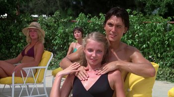 Movie still from “Caddyshack” (1980), directed by Harold Ramis – A man and a woman sitting next to each other; Medium shot, Low angle