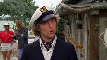 Movie still from “Caddyshack” (1980), directed by Harold Ramis – A man in a sailor's hat and tie; Close Up shot, Over the shoulder angle