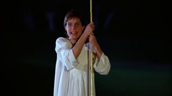 Movie still from “Caddyshack” (1980), directed by Harold Ramis – A young girl in a white dress holding a pole; Medium shot, Low angle