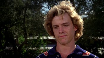 Movie still from “Caddyshack” (1980), directed by Harold Ramis – A young man with blonde hair and a blue shirt; Close Up shot, Low angle